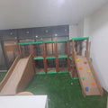 INDOOR PLAY STRUCTURE WITH SLIDES AND CLIMBING AREA